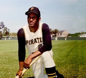 Roberto Clemente poses with bat in hand.