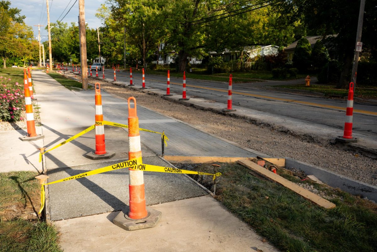 Construction obstructs the sidewalk in some places along East College Street. 