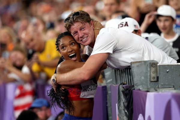 The Woodhalls embrace after Tara's victory in the women's long jump.