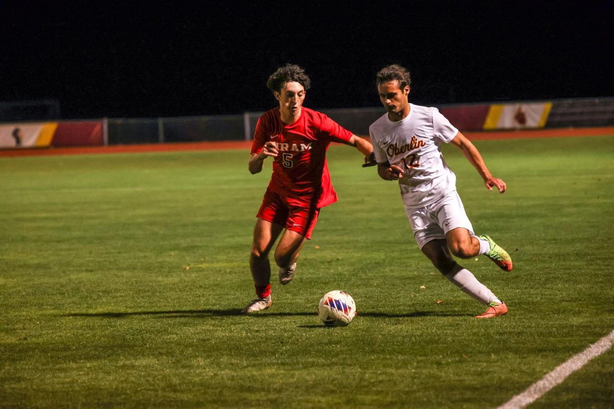 Fourth-year forward Toby Wells-Zimmerman dribbles past defender.