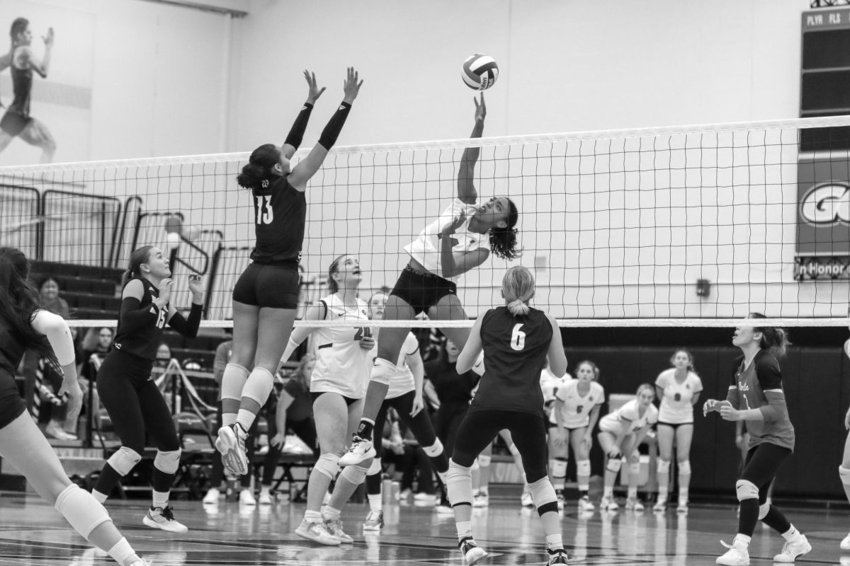 Cami Sweet tips the ball at the game against The College of Wooster.