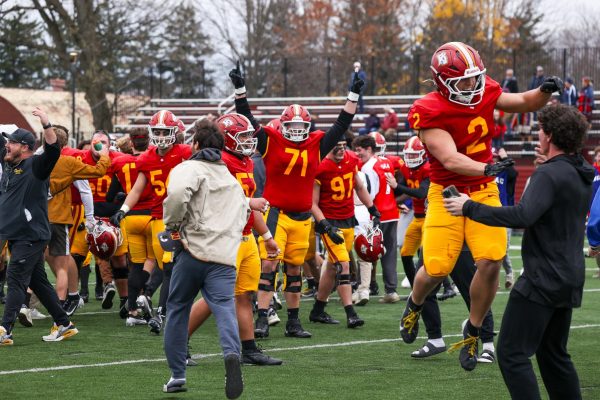 The football team celebrates after defeating Hiram College on Senior Day to earn their first win of the season.
