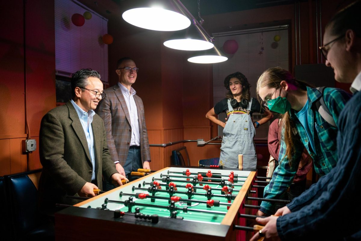 Dean Kamitsuka and Dean Quillen play foosball against students in The ’Sco on Tuesday.