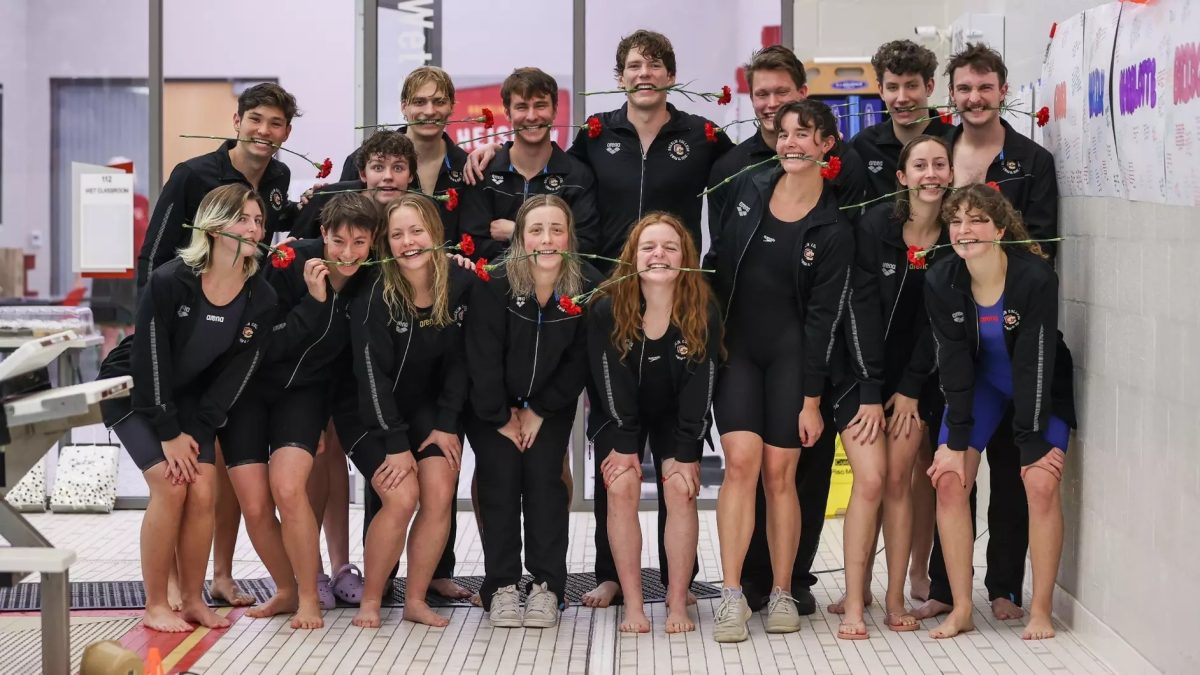 Senior members of the swim and dive team pose after Senior Day victories.