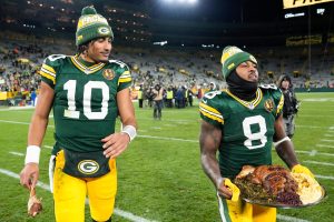 Packers QB Jordan Love and RB Josh Jacobs celebrate their 30-17 Thanksgiving Day victory over the Miami Dolphins.