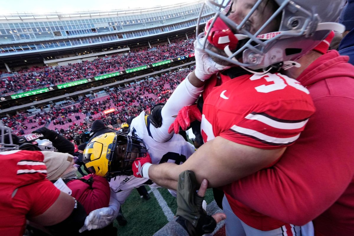 Gabe Powers and Kenneth Grant brawl after Michigan upsets Ohio State.