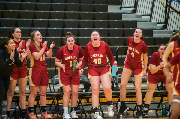 Oberlin women’s basketball celebrates after expanding their lead against The College of Wooster.