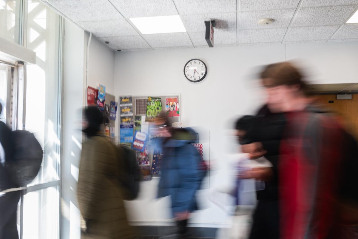 Students pass between classes in the King Building.