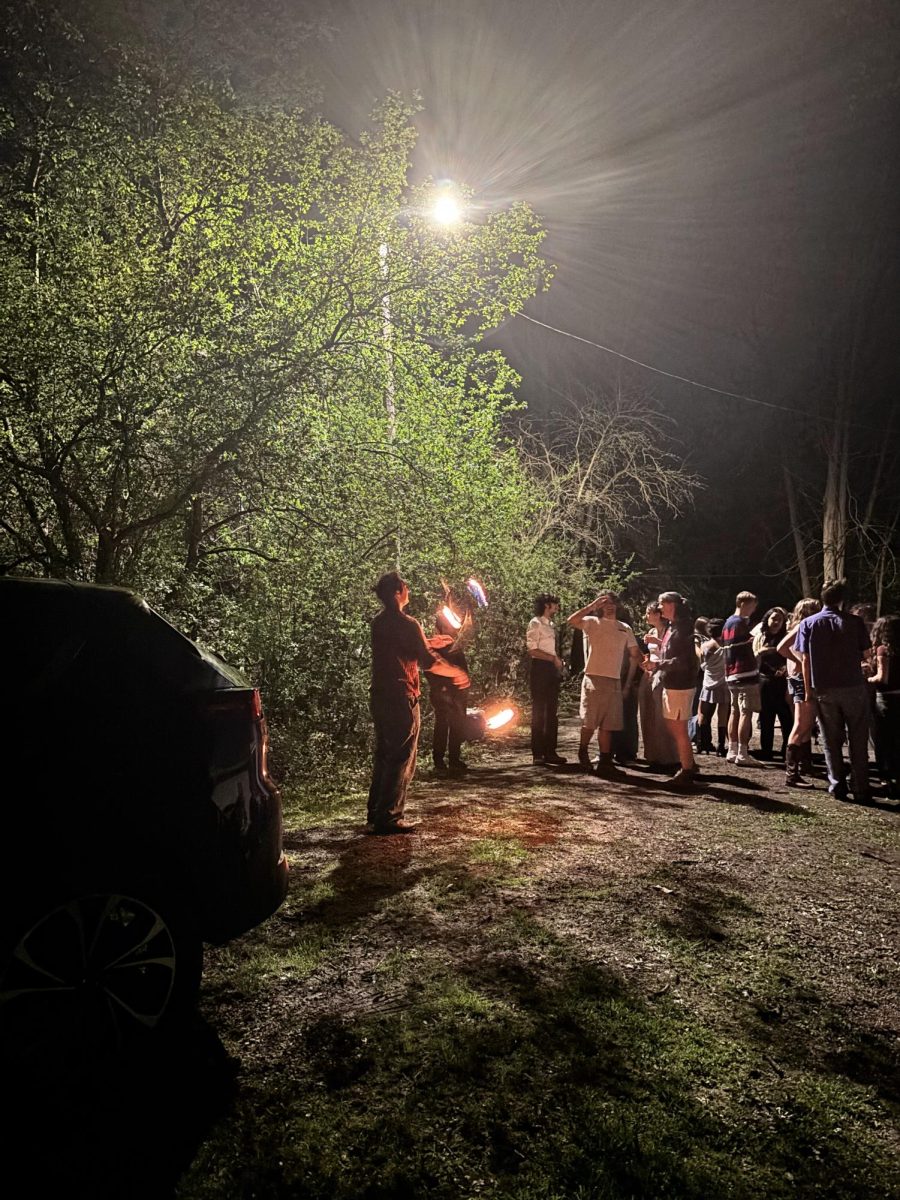 Students mill outside a house party.