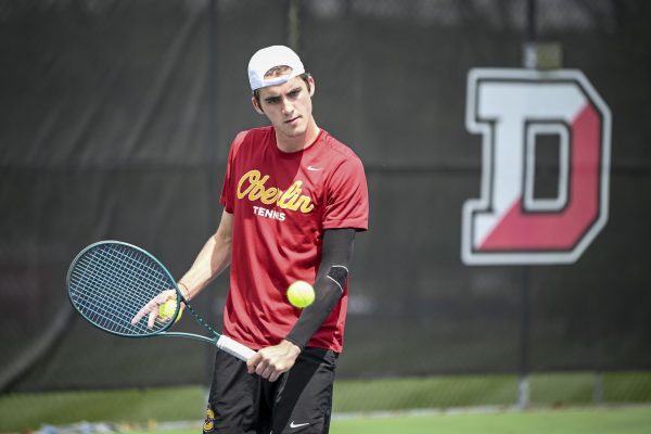 Second-year Brady Huggett returns a backhand in the first round of the NCAC playoffs against The College of Wooster.